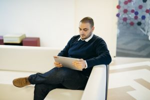 Elie sitting down reading a tablet at Microsoft's Dublin office